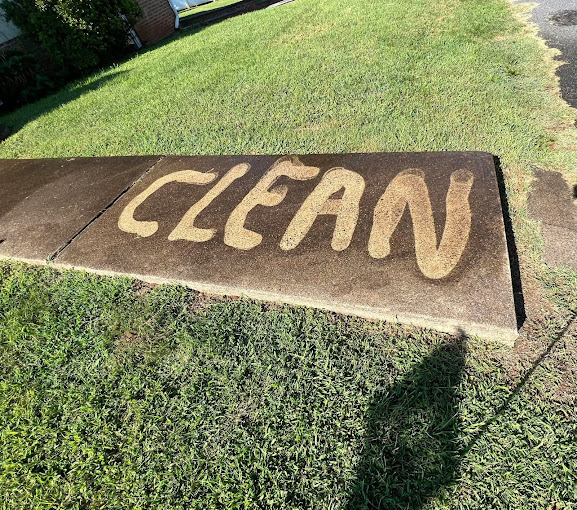 "Clean" sprayed into dirty sidewalk to show the difference